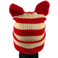 Red and white striped knitted hat with ears on a mannequin head against a plain background